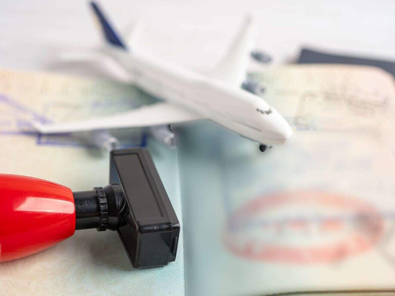 Home Residency Rule image, plane and stamp with visa