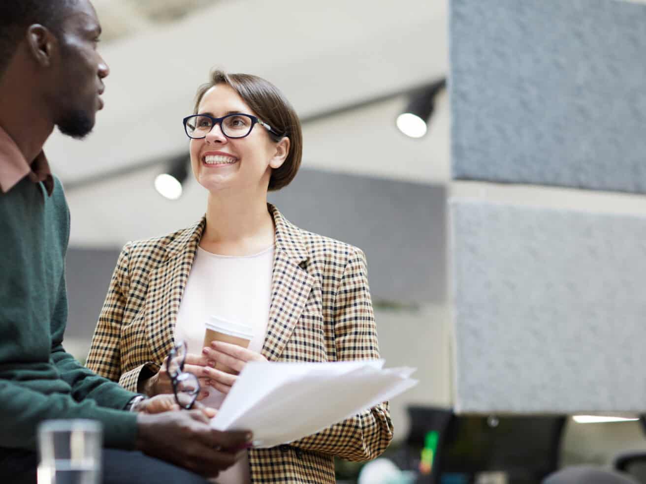 intern at a table working alongside colleagues